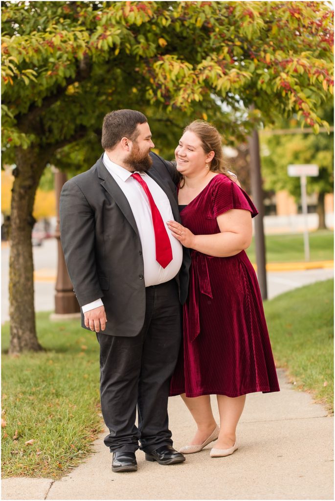 engaged couple in suit and velvet dress