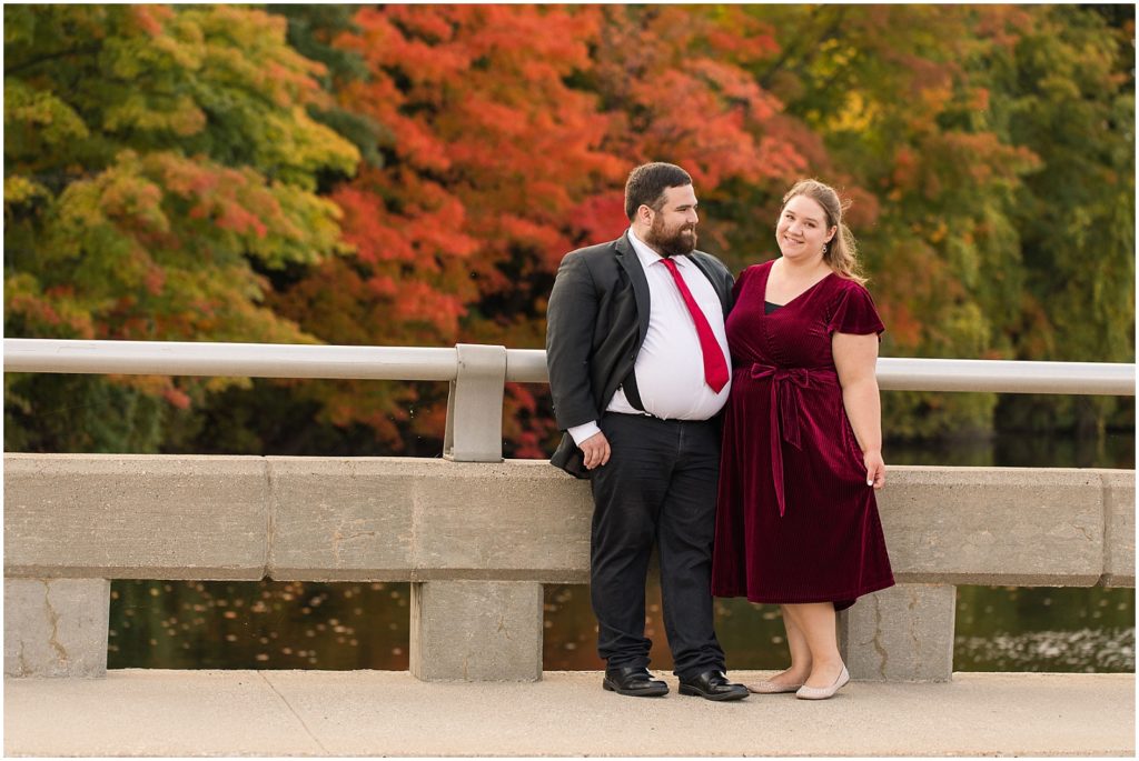 formal engaged couple by fall foliage