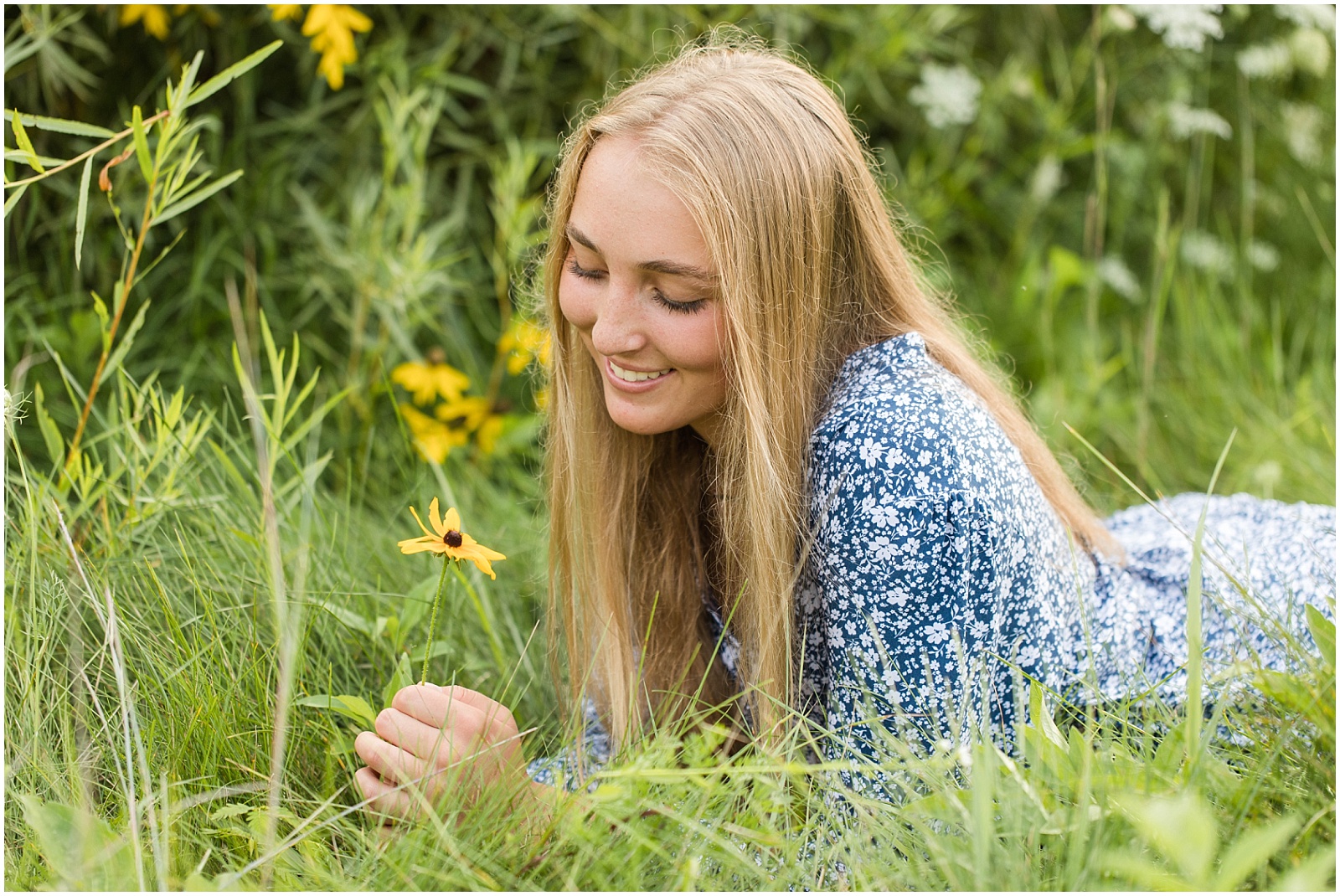 senior girl in field of flowers