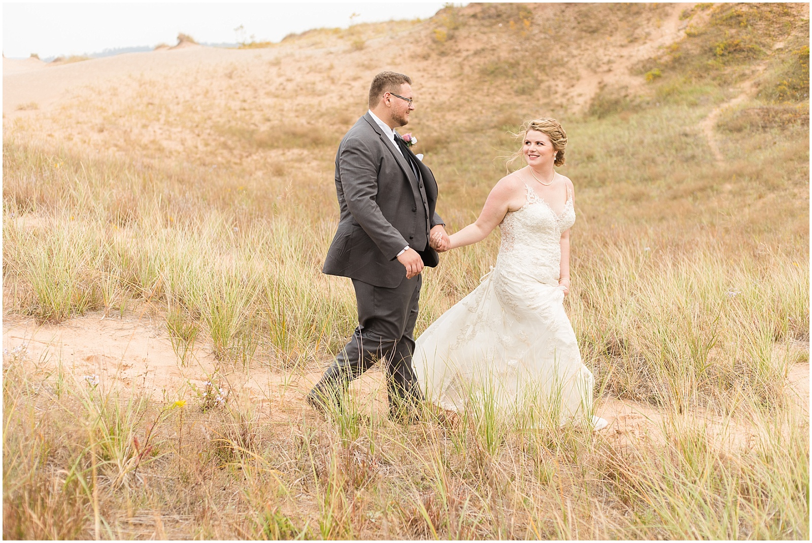 bride and groom on sand dunes