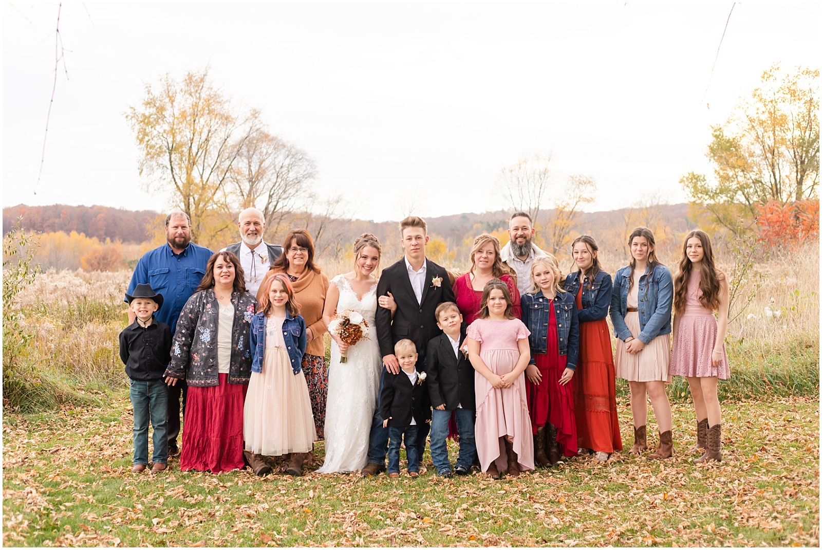 large family photo at fall wedding